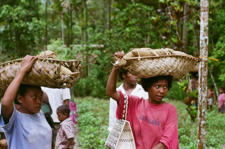 Figure 2. Women of Buitowolo village going to a muli hosted by Tupwagidu village.